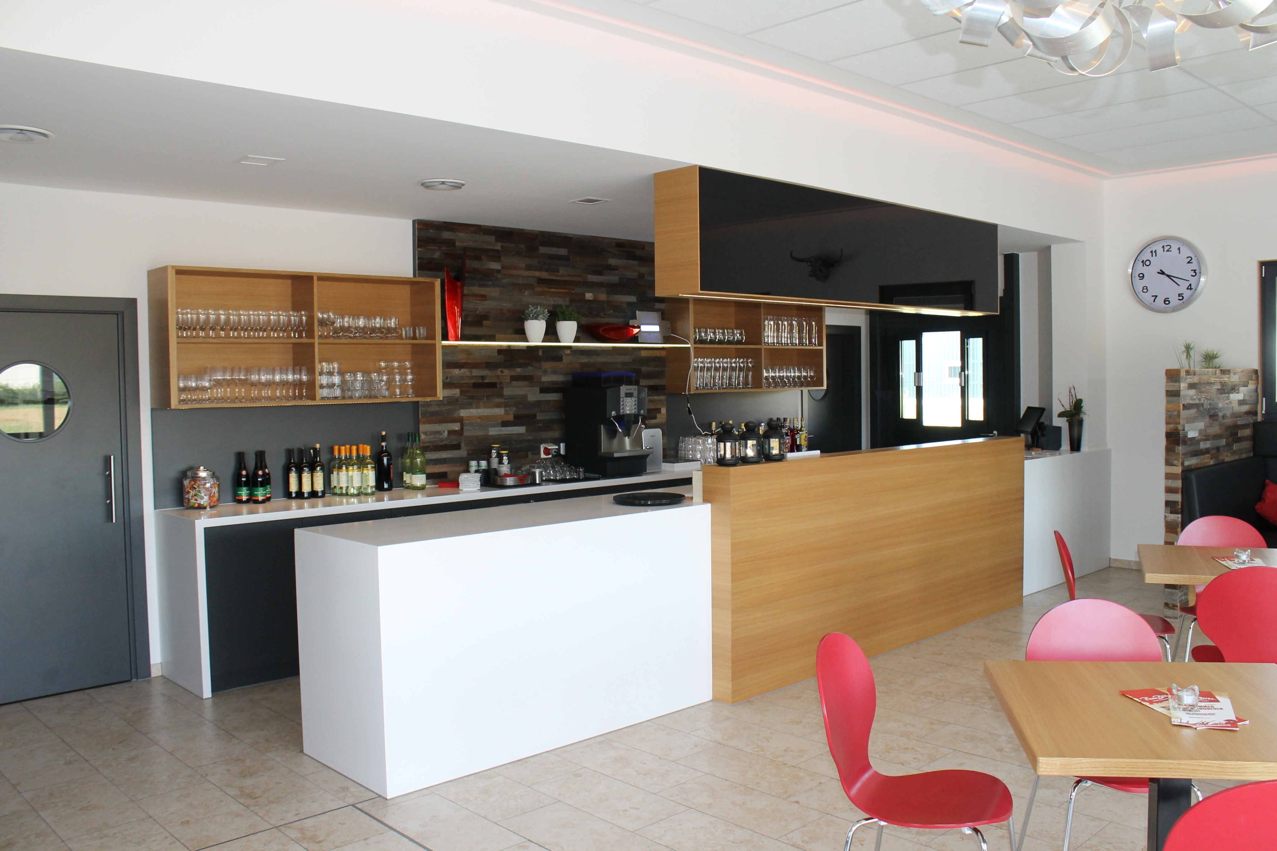 Ansicht einer Bar mit großer Inseltheke in weiß und in Holz